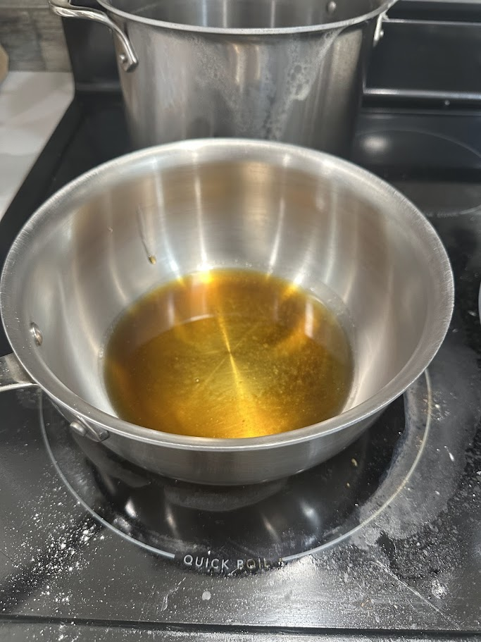 Saucepan with simmering maple syrup for homemade gel